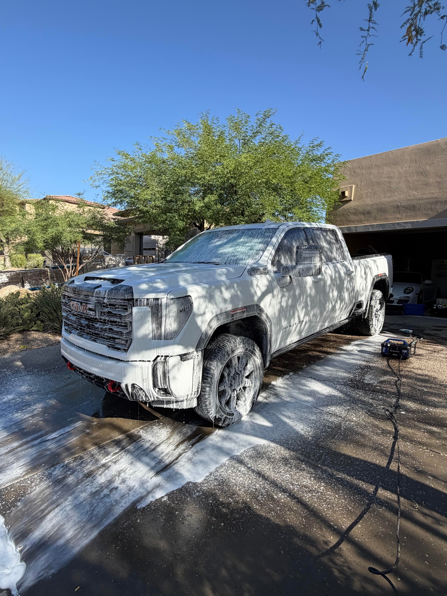 GMC truck covered in foam during exterior wash