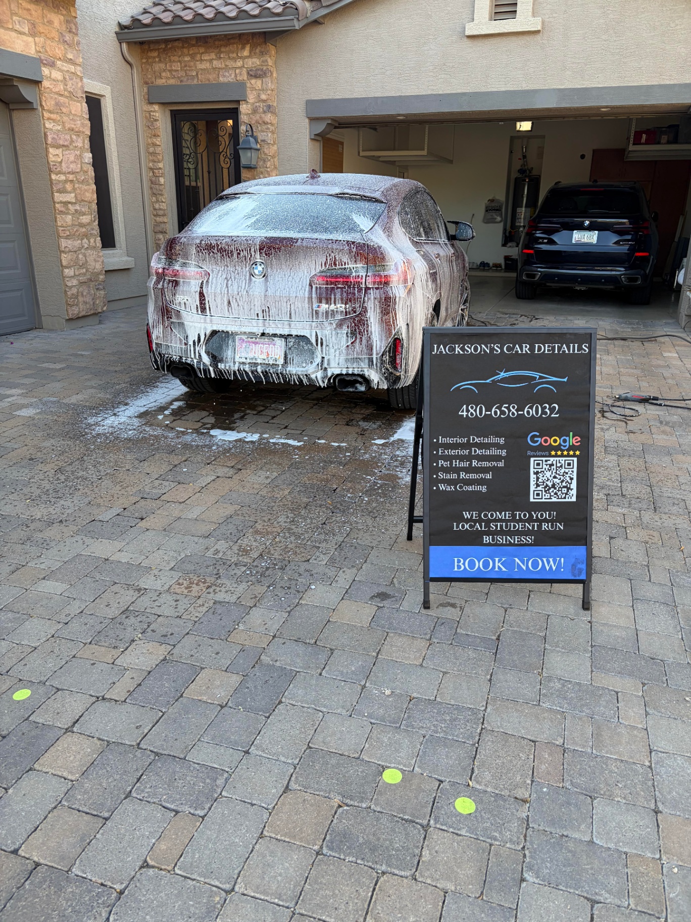 BMW being foam washed in the driveway